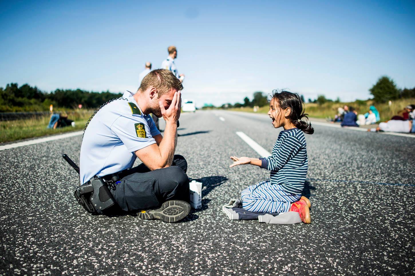 Danish police officer playing “hide the ring” with Syrian refugee