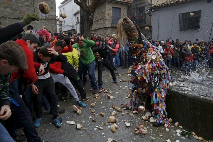 Revellers throw turnips at the Jarramplas during the Jarramplas traditional festival in Piornal, Spain.