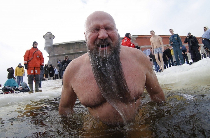 A man immerses himself in icy waters during celebrations for the Orthodox Epiphany on the ice-covered lake near St. Petersburg, Russia.