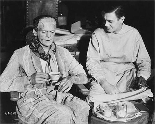 British actor Boris Karloff who played the monster having a cup of tea with actor Colin Clive who portrayed Dr. Frankenstein.