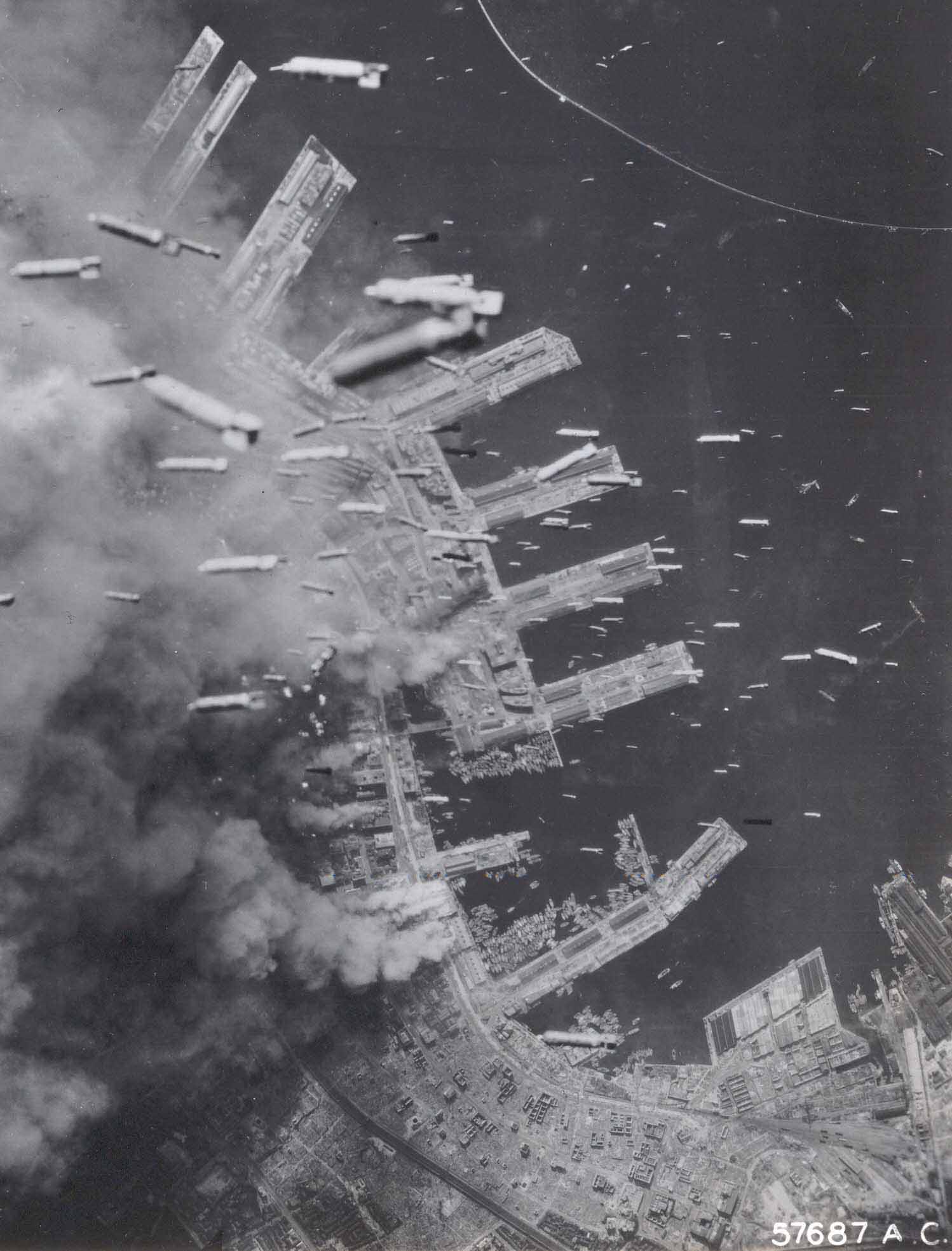 A bomber rains death and destruction on Kobe, Japan, 1945.
