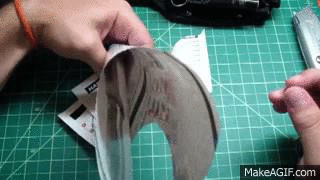 cutting with a paper knife gif - MakeAGIF.com