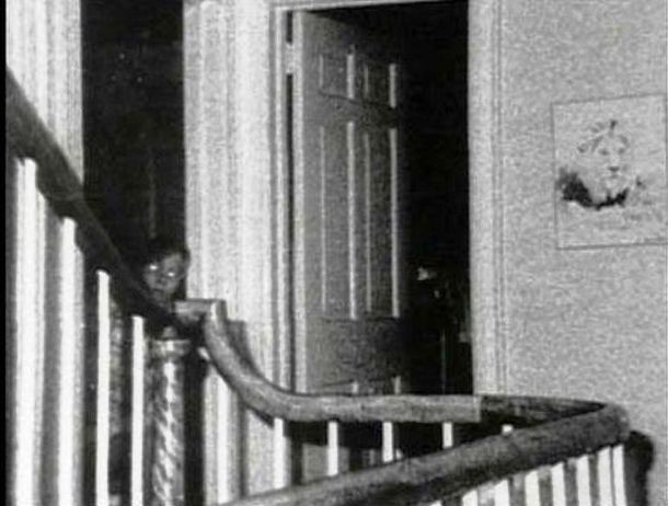 This photo was allegedly taken inside a house in Amityville, New York, in 1976. One of the most famous paranormal photos of all time, it features what appears to be a young boy with white eyes who is peaking out of a doorway. The figure is speculated to be the ghost of John Defeo, a nine-year old boy who had lived in the house earlier and was murdered there.