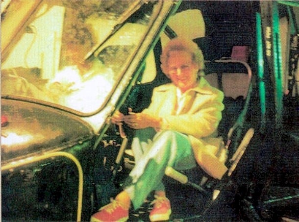 In 1987, Mrs. Sayer and her friends were visiting the Fleet Air Arm Station at Yelverton, Somerset, UK, when this photo was taken. Mrs Sayer´s friends took this photo with her sitting in the seat of a retired helicopter. When the picture was taken, Mrs. Sayer was alone in the vehicle but upon development of the photo, a bright figure sitting next to her can be clearly seen.