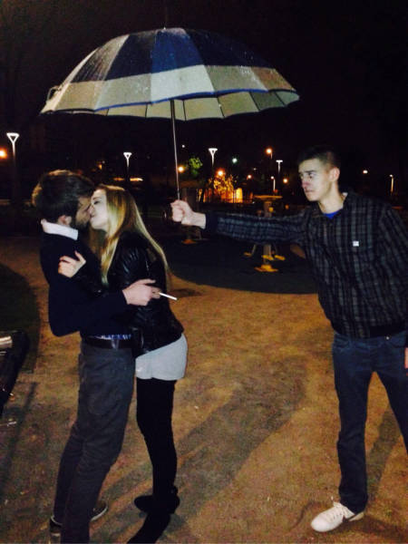 holding a umbrella for a couple