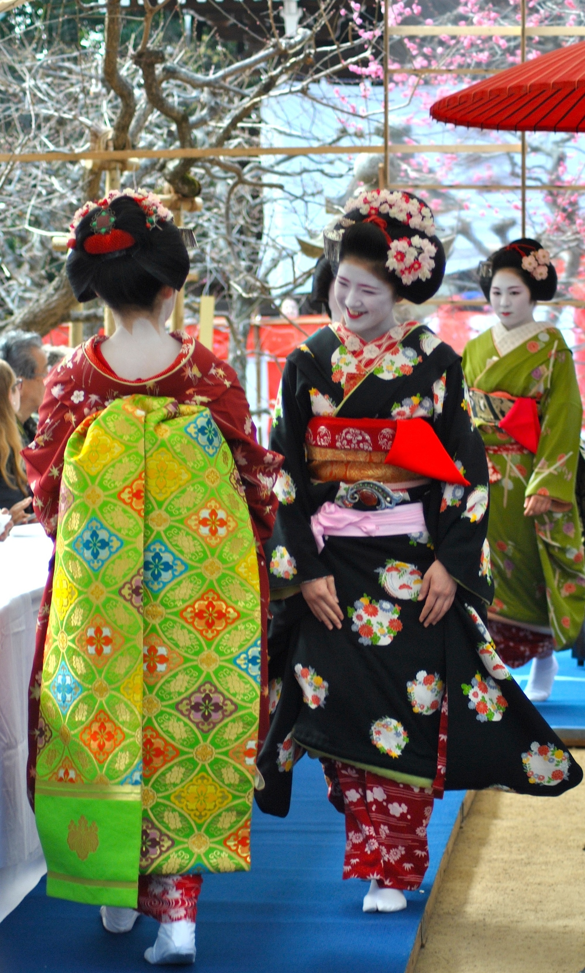 Maiko, or apprentice geisha, greet each one another with soft smiles