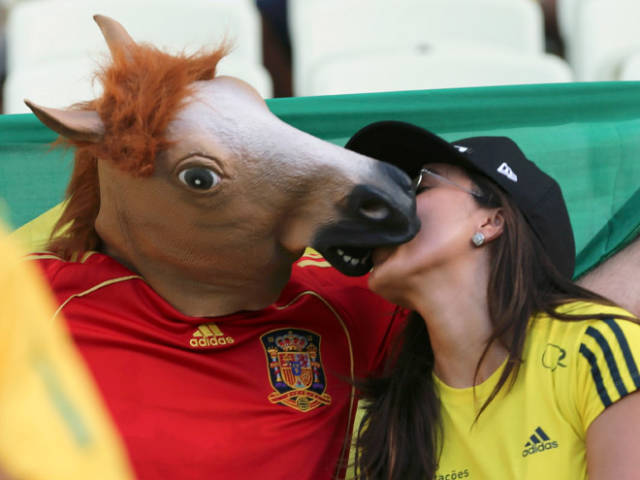 human with horse mask kissing human