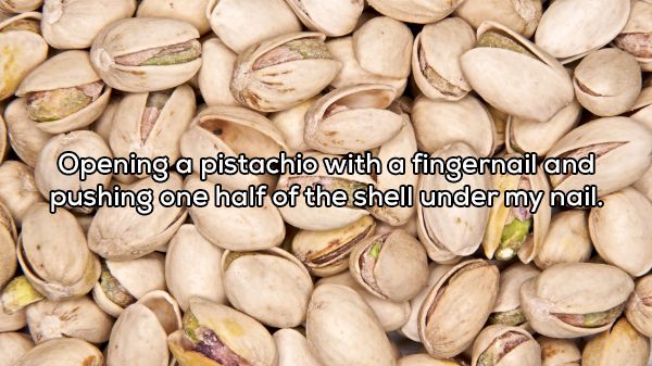 california pistachios - Opening a pistachio with a fingernail and pushing one half of the shell under my nail.