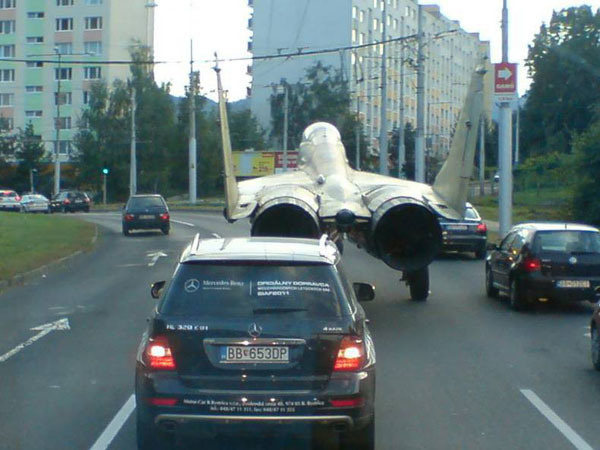 An airplane nonchalantly on the road.
