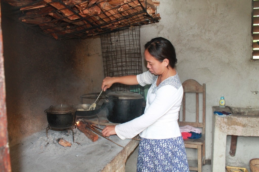 A woman cooks at a relative's house in Dalaguete, Cebu, Philippines.
