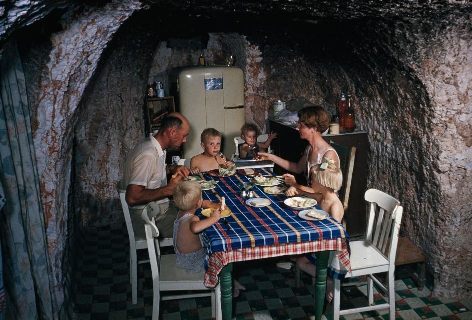 A miner eats with his family at their home in Coober Pedy, a town in northern South Australia (1963).