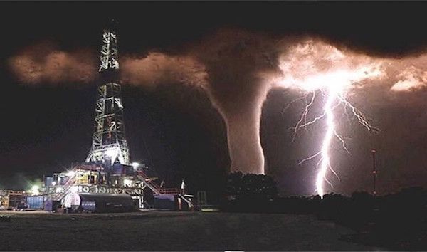 The Oil Rig Storm.
While the lightning and water spout is real, the oil rig was added in later. The original photo was taken by Fred Smith, in Florida, 1991.