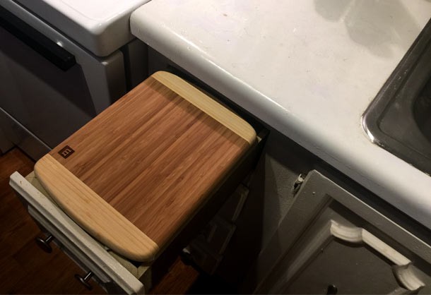 Placing a cutting board on a drawer makes extra counter space in small kitchens.