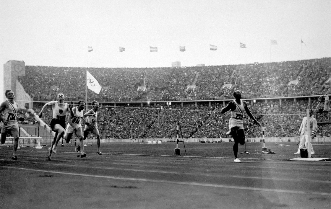 Jesse Owens crosses the finish line in Berlin to win the 100-meter sprint August 3 1936