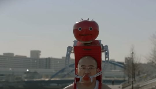 A Japanese company has invented a robot that sits on your back and feeds you tomatoes while you run
