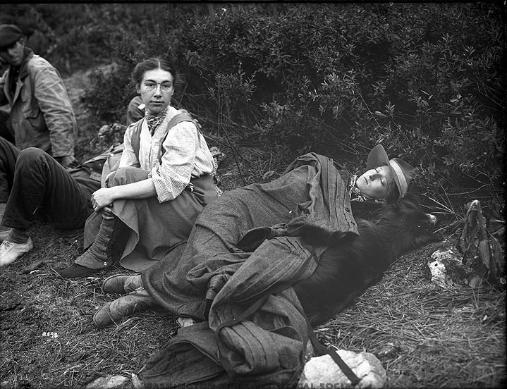 1907: Two female hikers in gaiters take a break on their camping trip in the Olympic Mountain Range, Washington State.
