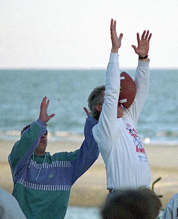 1993: Former President Bill Clinton misses the ball while playing on the beach in South Carolina.