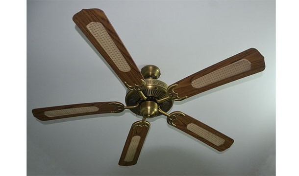 Ceiling fans have a switch for winter mode where the blades spin backwards slowly. This causes the trapped warm air near the ceiling to flow back down to the floor by way of the walls.