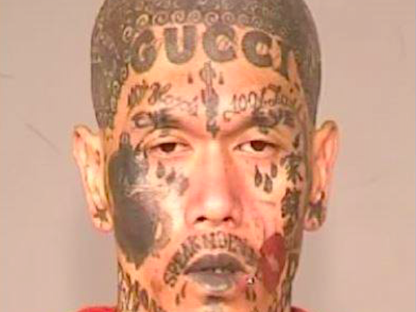 A Fresno man was arrested in March 2016 for possession of firearms and cultivation of marijuana, but it's his tattoo-covered booking photo that set his arrest apart from most. 

Khamprasong Thammavong, 33, a documented Laos Blood gang member, was pulled over in Fresno, California for a routine traffic stop. When the officer ran Thammavong's information, he discovered that the gang member was out on probation and called for backup.

Officers who then searched Thammavong's home found “numerous” signs of his gang affiliation, and a further search turned up a semi-automatic rifle and a semi-automatic handgun. Police also found tactical gear similar to police-issue equipment, and 38 illegal marijuana plants. 

Thammavong was booked into the Fresno County Jail on several felony charges, including being a felon in possession of a firearm, and cultivation of marijuana. His mugshot, of course, has gone viral.