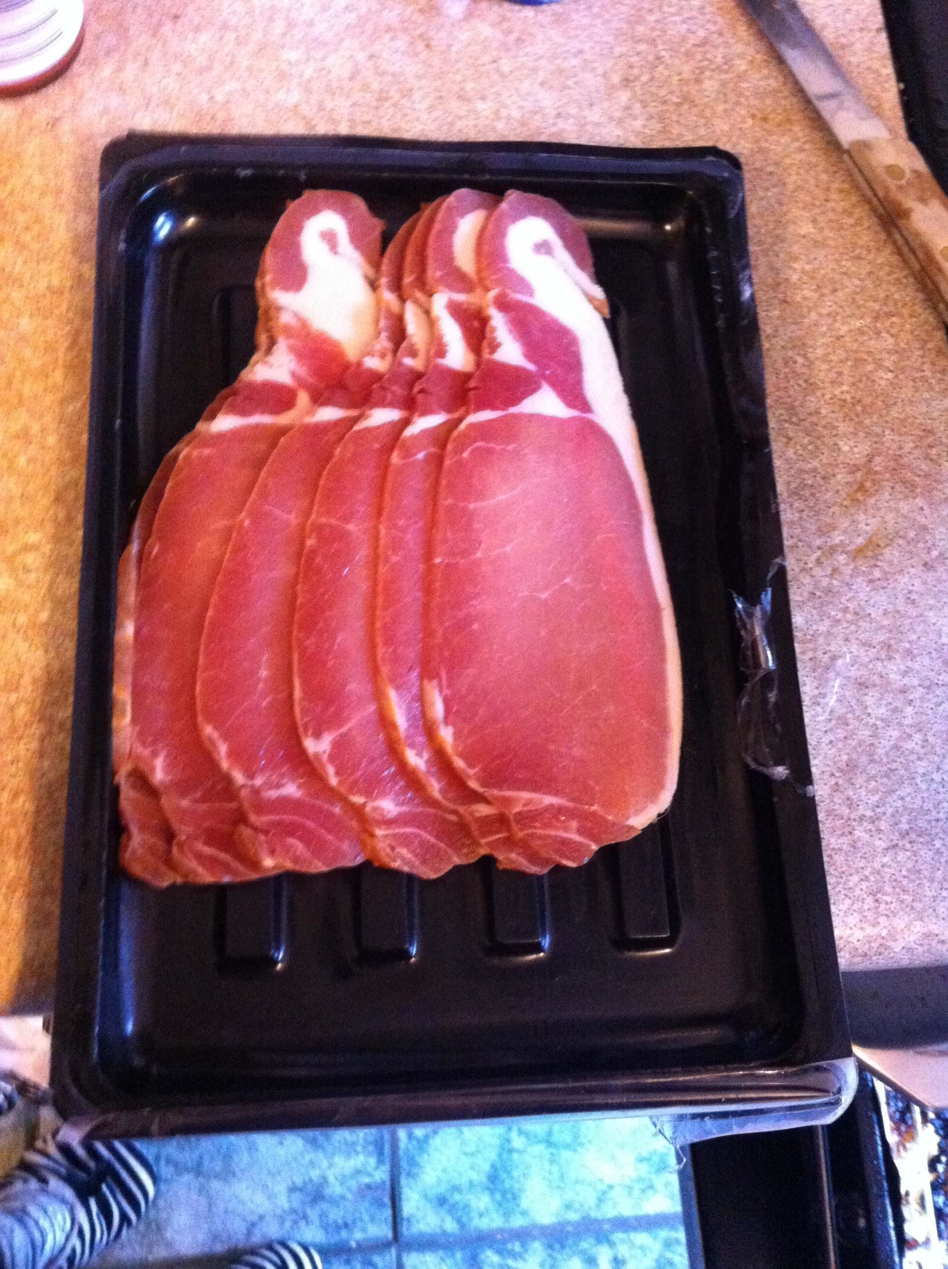 A stack of bacon that looks like a stack of penguins.