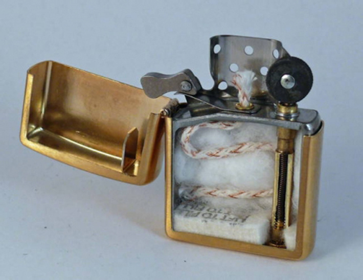The inside of zippo lighter by cutting it in half.