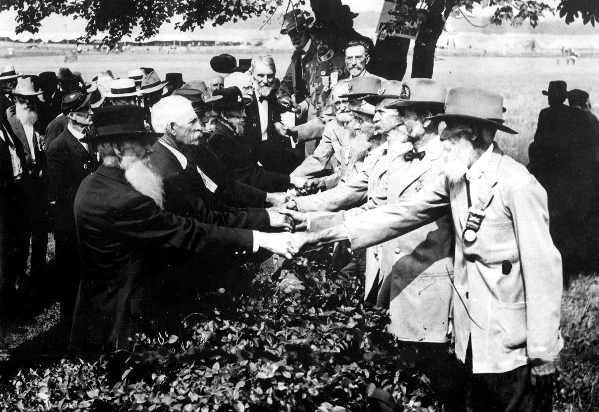 At the 50th anniversary of the battle of Gettysburg, Union (left) and Confederate (right) veterans shake hands.
