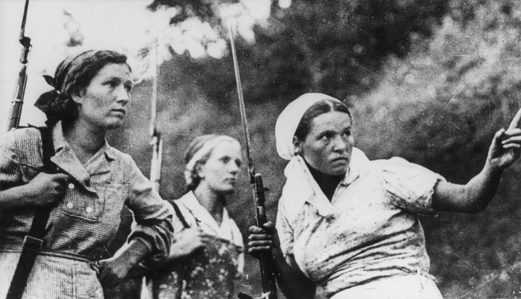 Three Soviet women guerrillas in action in Russia during World War II.