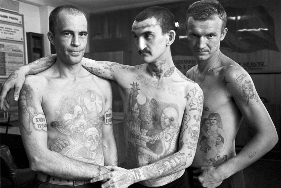 Back then in prison, Tattoos hold intricate meaning. It wasn’t worn for fashion. It has to be earned – the hard way.
Tattoos indicate a ranking in prison, otherwise known as “The Zone”. The Zone, notoriously vicious, deadly & overcrowded (with more than 100 prisoners in a small jail cell), is controlled by a main group of criminals called the “Thieves-in-Law”, the highest named as “The Godfather”- sitting atop a complex hierarchy of criminals (the guys who make the rules), while the weakest prisoners (the “downcasts”) are at the bottom.
A heavily tattooed person indicates a very high rank, as he is literally one of the toughest guys there – who, before he earned it, suffered and survived beatings and committed a lot of crimes and murders. A downcast who attempts to get a tattoo without the approval of the thieves gets killed without question.