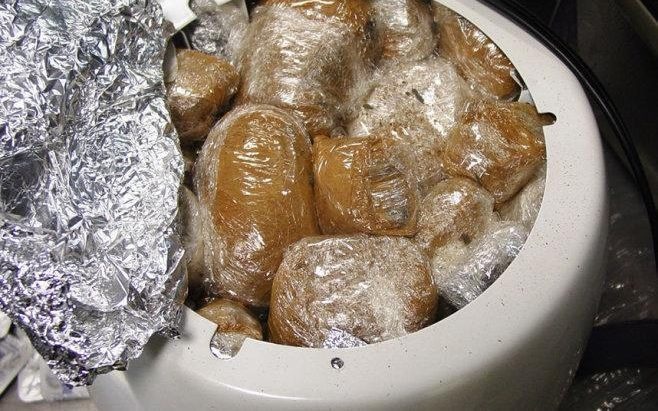Officials discovered a rice cooker stuffed with three pounds of black opium, which had been coated in cinnamon and wrapped in plastic. The man was attempting to leave the states and head back to Iran.
