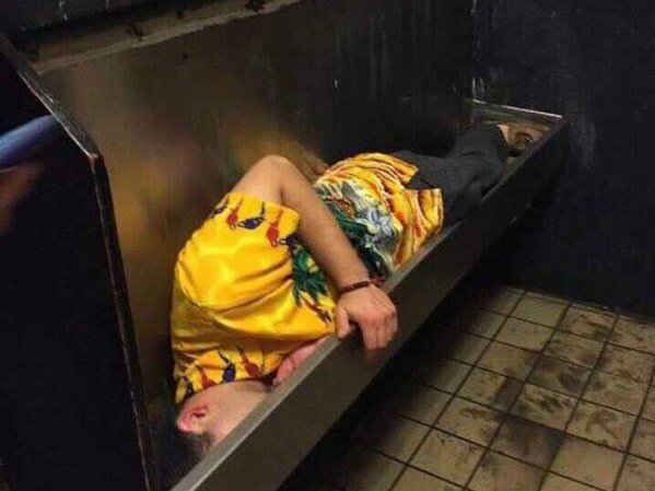 passed out in urinal trough