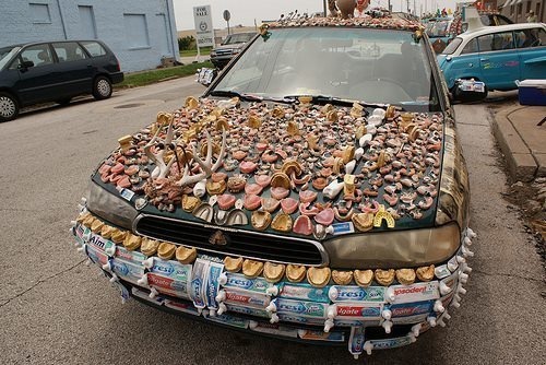 This car is covered in dentures, impression trays, toothpaste tubes, and antlers.