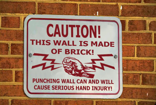 unnecessary signs - Caution! This Wall Is Made Of Brick! Punching Wall Can And Will Cause Serious Hand Injury!