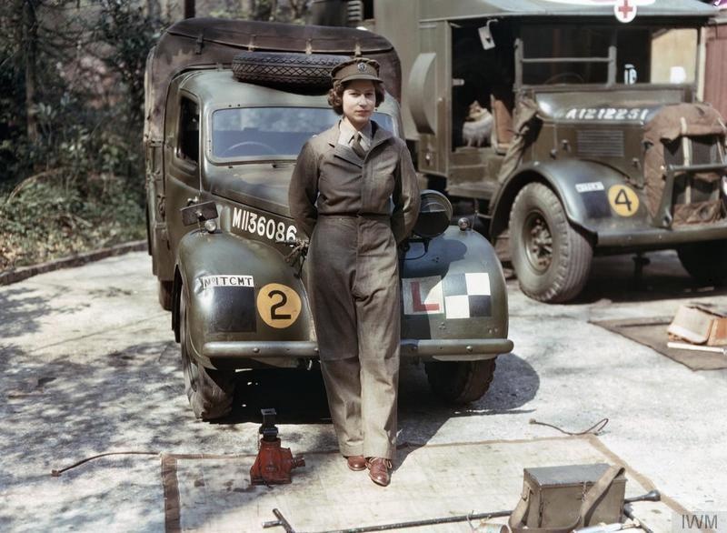 Princess Elizabeth standing in front of a military truck in 1945.