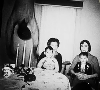 The Copper's took a family photo at their new home. When the film was developed, a dead body hanging upside down eerily appeared.
