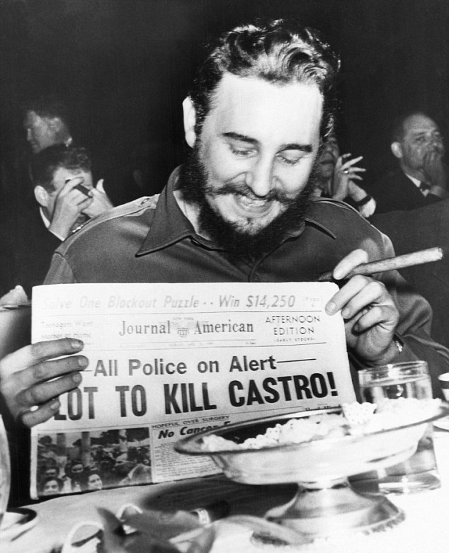 Fidel Castro holds up a newspaper with a story about a plot to kill him, which happened in 1959.