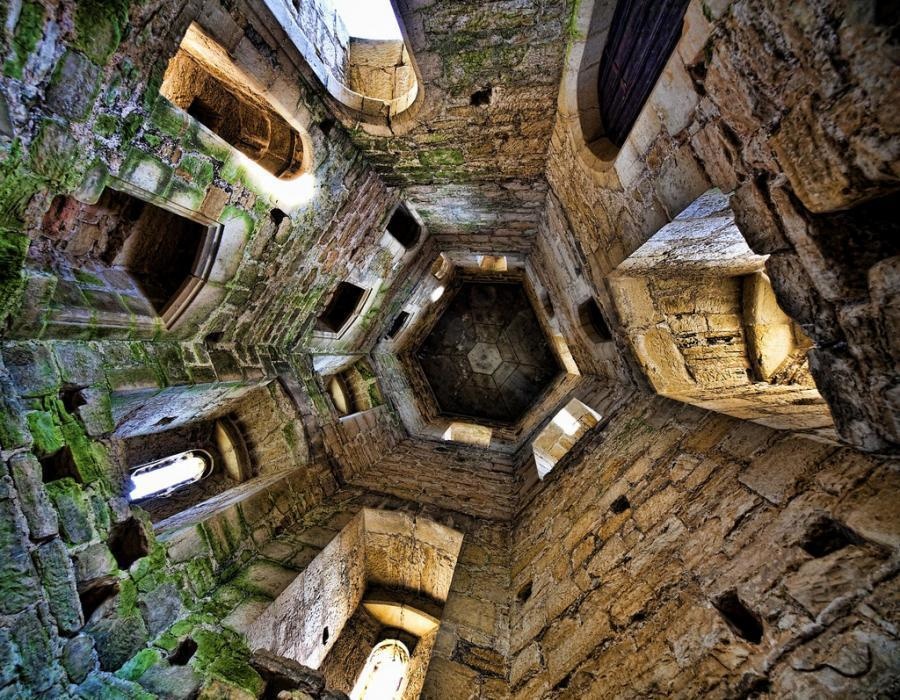 In the middle of one of the towers of the Bodiam Castle in England.
