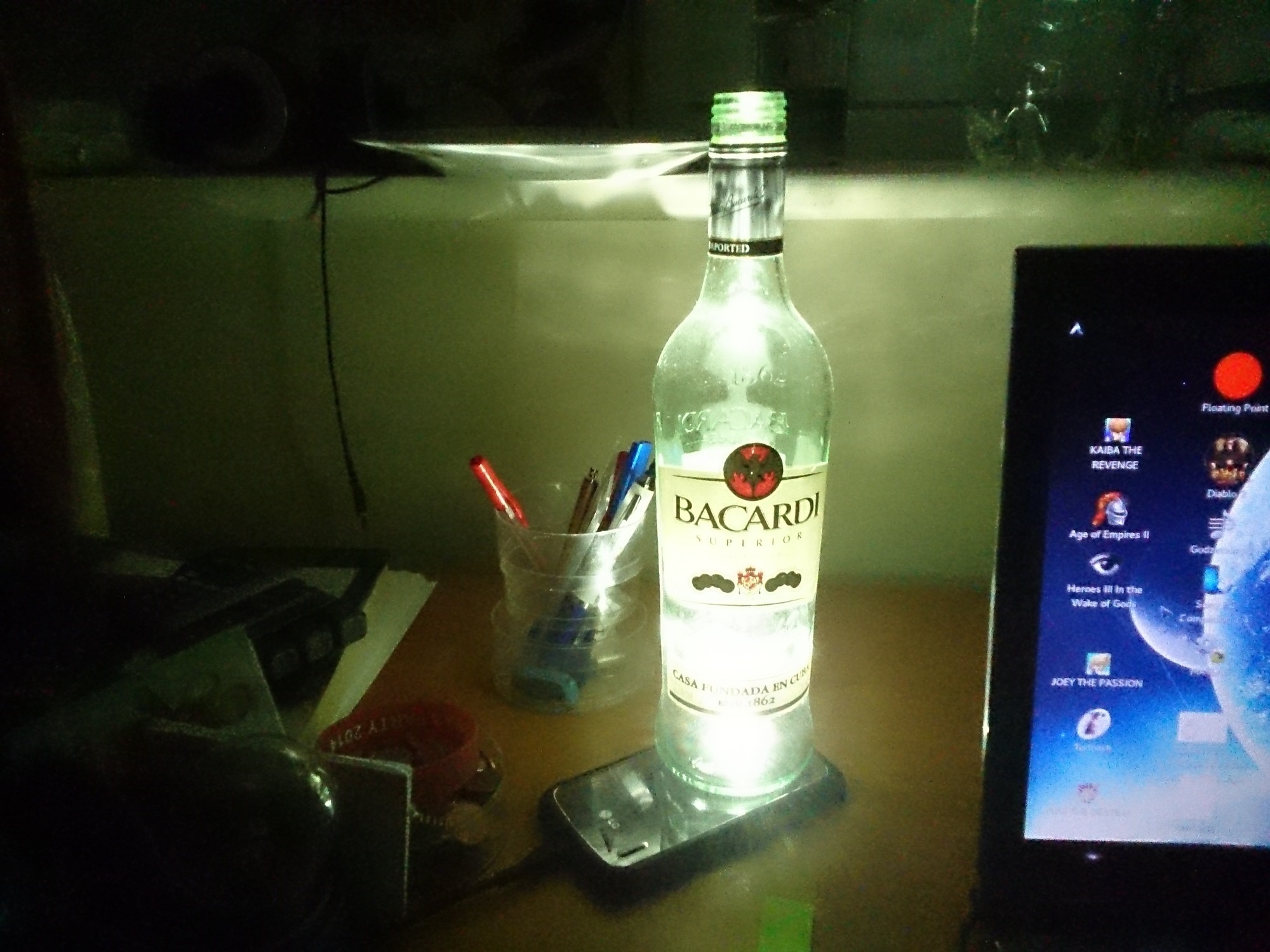 Your empty bottle of Bacardi can come in handy when the lights go out.