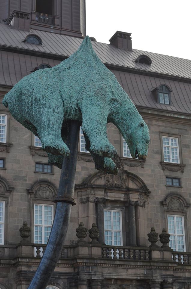 Statue of a polar bear impaled on a oil supply line, dumped infront of the danish parliament