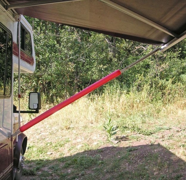 Put up foam noodles to stop injuries.

For particular people, accidents are inevitable but remove the possibility of someone hitting their head on the awning strut by putting a foam noodle on it.