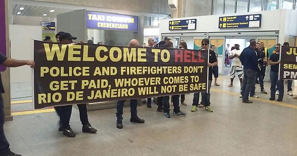 Welcome to Hell. Brazilian cops and firefighters protest in the airport for incoming tourists