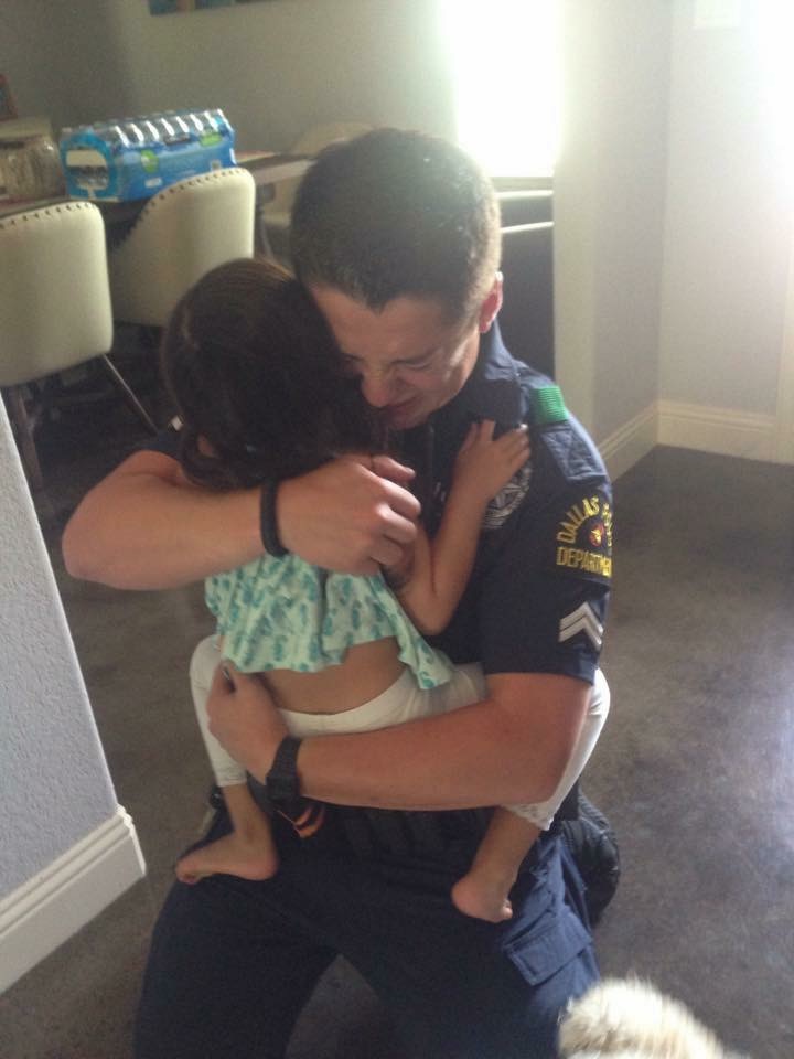A Dallas police officer after coming home from a 15-hour shift on Thursday night