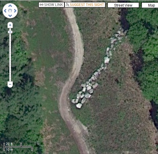 The Google cameras also caught this strange collection of rocks/

This is a strange pointing-style arrow created by arranging piles of stones near Sebago Lake in Cumberland County, Maine.