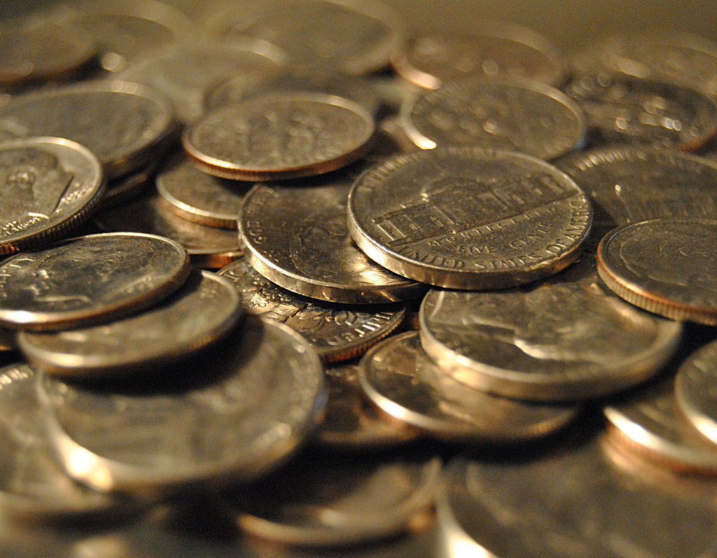 One lady paid with cash, and he had to break open a roll of nickels to give her change.

The roll of nickels exploded all over the floor. He got on all fours to pick up the mess. Meanwhile, the phone continued to ring.