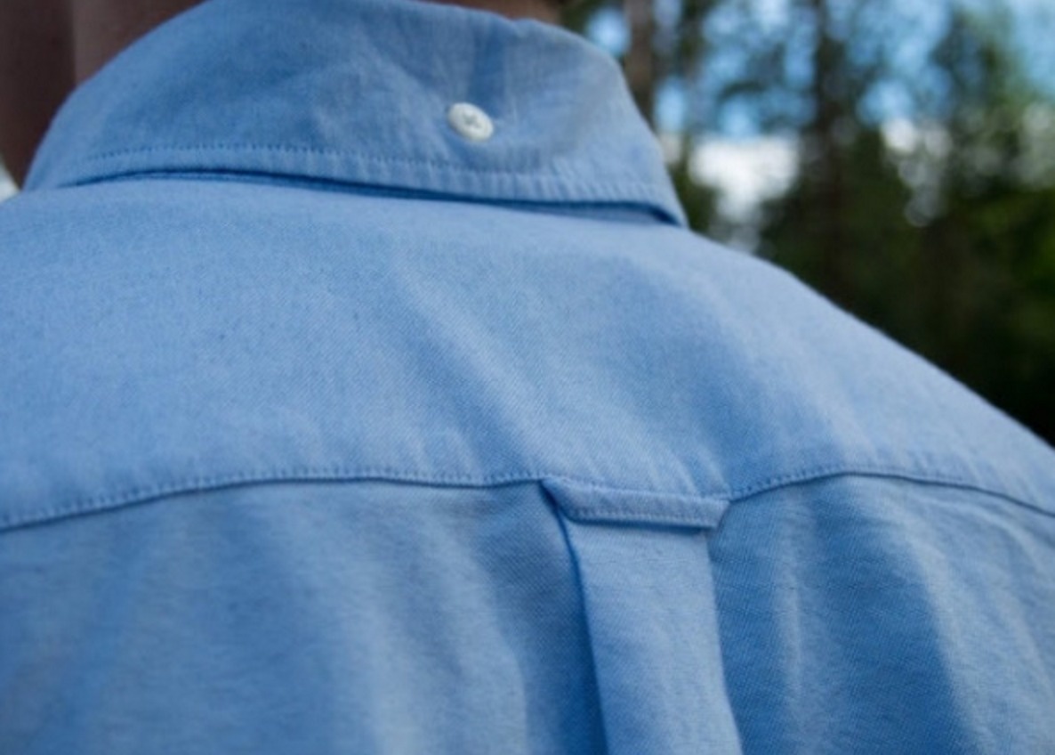 The back loop of your shirt isn't just so mom can grab you.

The loop on the back of your shirt is for your hanger to go on, to prevent the front and back of the shirt from wrinkling.