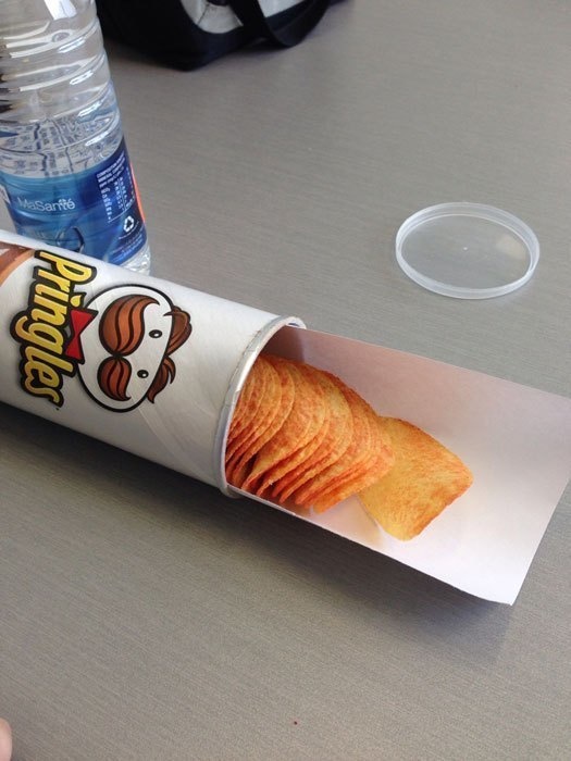 Slip a long piece of paper into a tube of chips so that when you tip the tube over, the chips have something to lay on top of.
No more crumbs at the end. No more sticking your arm all the way into the bottom of the tube.