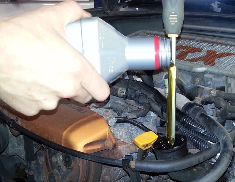 When you don't have a funnel handy and need to pour some oil in your car, use a screwdriver.
Just pour the oil against the screwdriver.