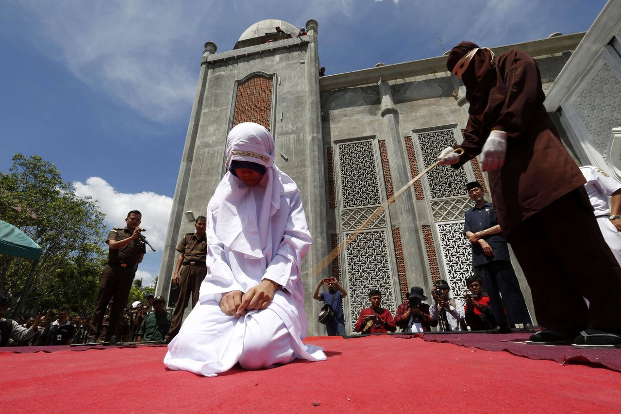 An Indonesian girl being publicly whipped yesterday for violating Shari’a law