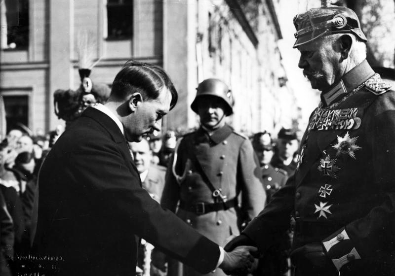 Adolf Hitler greets Paul von Hindenburg at the opening of the new Reichstag in Potsdam, Germany, 21 March 1933. This is a very famous photograph and very much calculated Nazi propaganda. Hitler had been chancellor for all of a month and half when this picture was taken, and Hindenburg had been very reluctant to appoint Hitler chancellor, and only did so after three separate parliamentary elections failed to yield a majority government. It was very important for Hitler, whose government very much appeared weak, tenuous, illegitimate, and divided to have some symbol of unity in the national government. More importantly for Hitler’s ambitions, he needed a symbol of continuity between the old imperial regime and the Nazi regime. This photo became that symbol.
