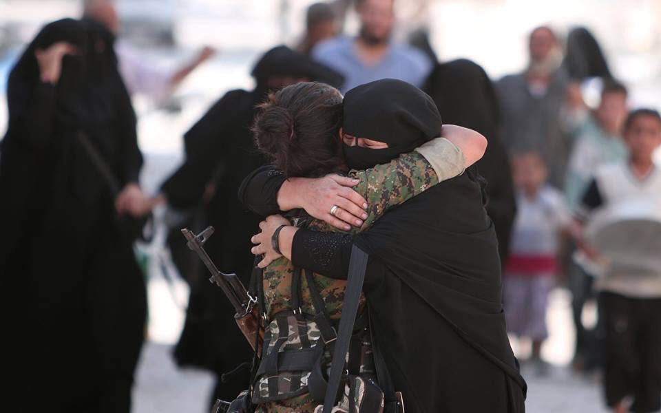 Woman hugs Kurdish fighter after liberation of Manbij from ISIS