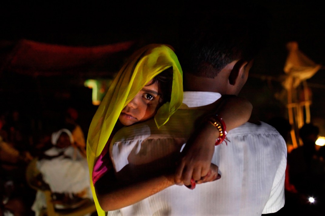 Rajani, 5, India. Long after midnight, Rajani is roused from sleep and carried by her uncle to her wedding. Child marriage is illegal in India, so ceremonies are often held in the wee hours of the morning. It becomes a secret the whole village keeps, explained one farmer.